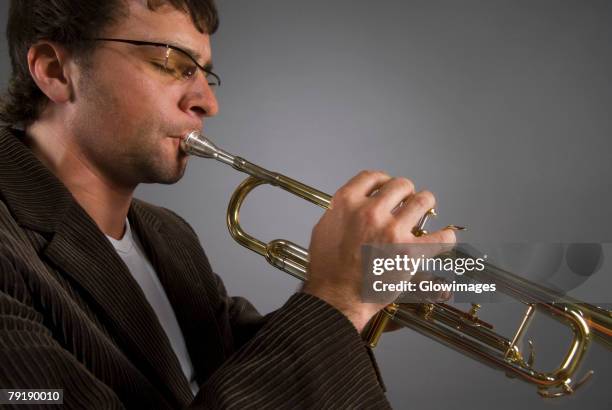close-up of a male musician playing a trumpet - trumpet stock pictures, royalty-free photos & images