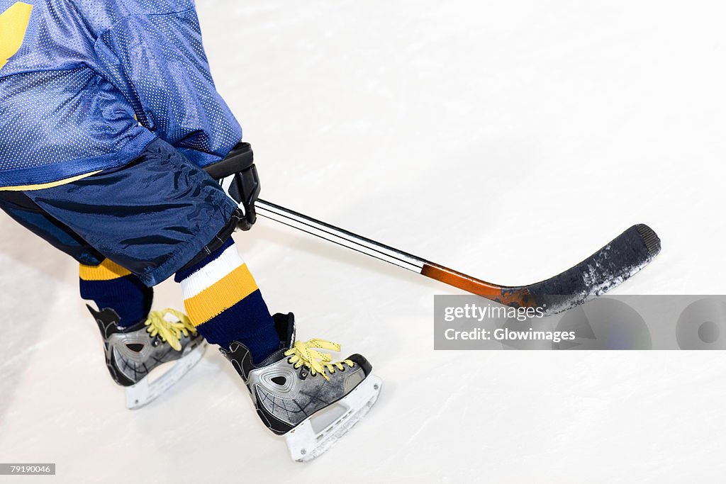 Rear view of a man playing ice hockey