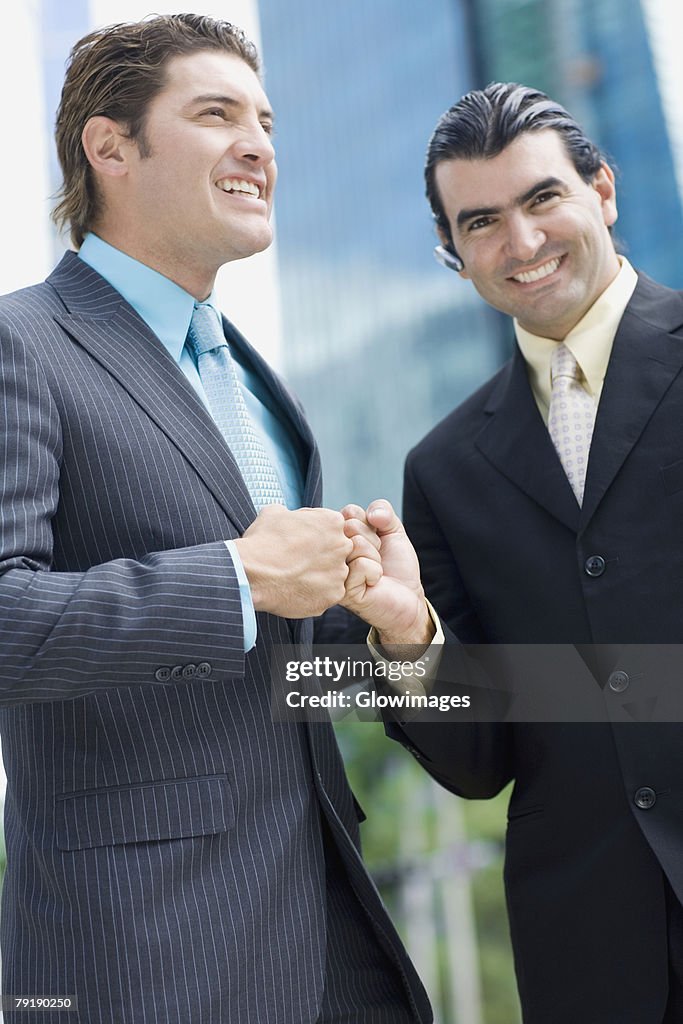 Two businessmen touching fists