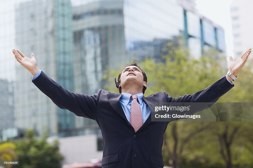 Businessman standing with his arms outstretched