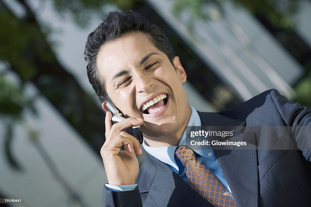 Businessman talking on a mobile phone and smiling