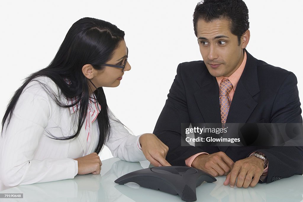 Close-up of a businessman and a businesswoman discussing in a boardroom