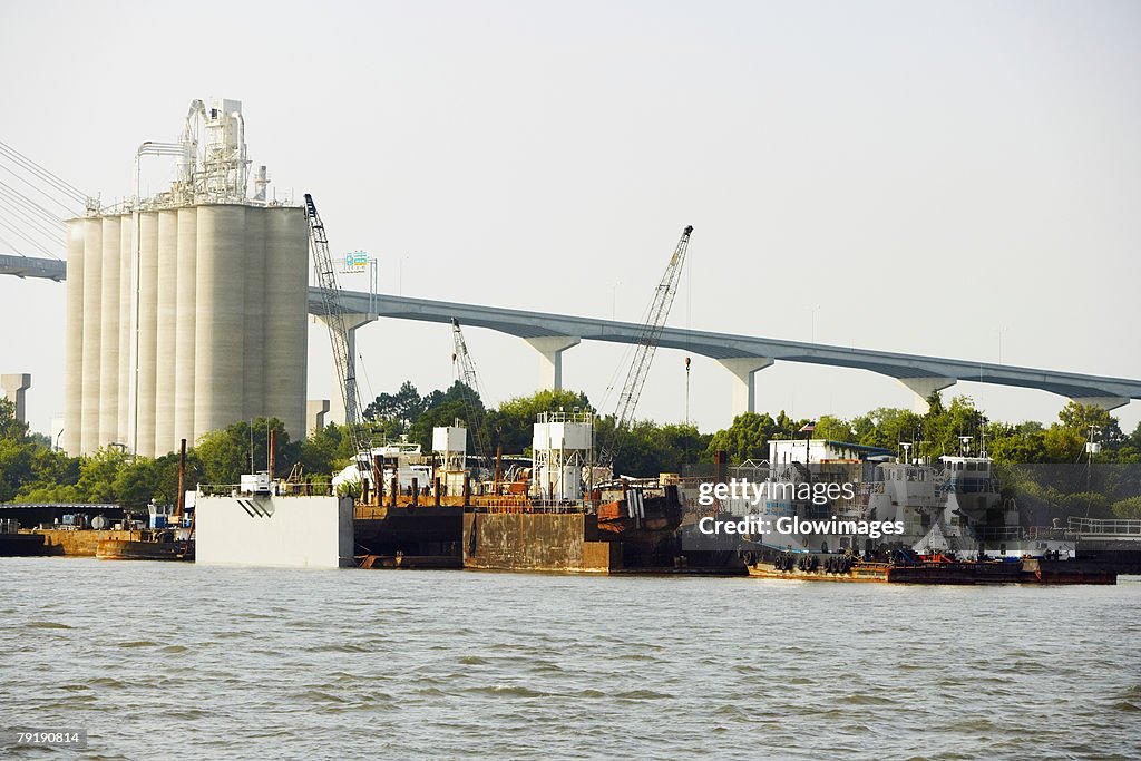 Commercial dock with a bridge in the background, Savannah, Georgia, USA