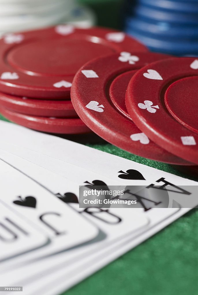 Close-up of the poker of spades with gambling chips on a gambling table