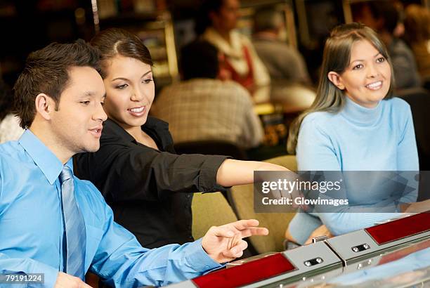 mid adult man with a teenage girl and a young woman in a casino - teen pokies stock pictures, royalty-free photos & images