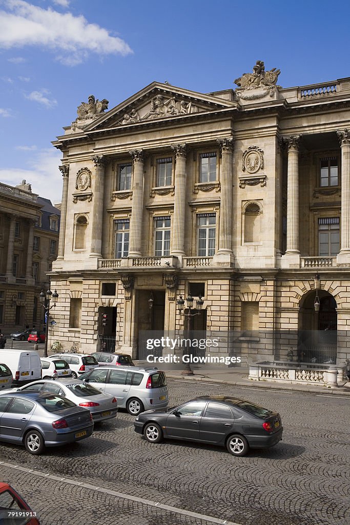 Traffic on a road in front of a building, Paris, France