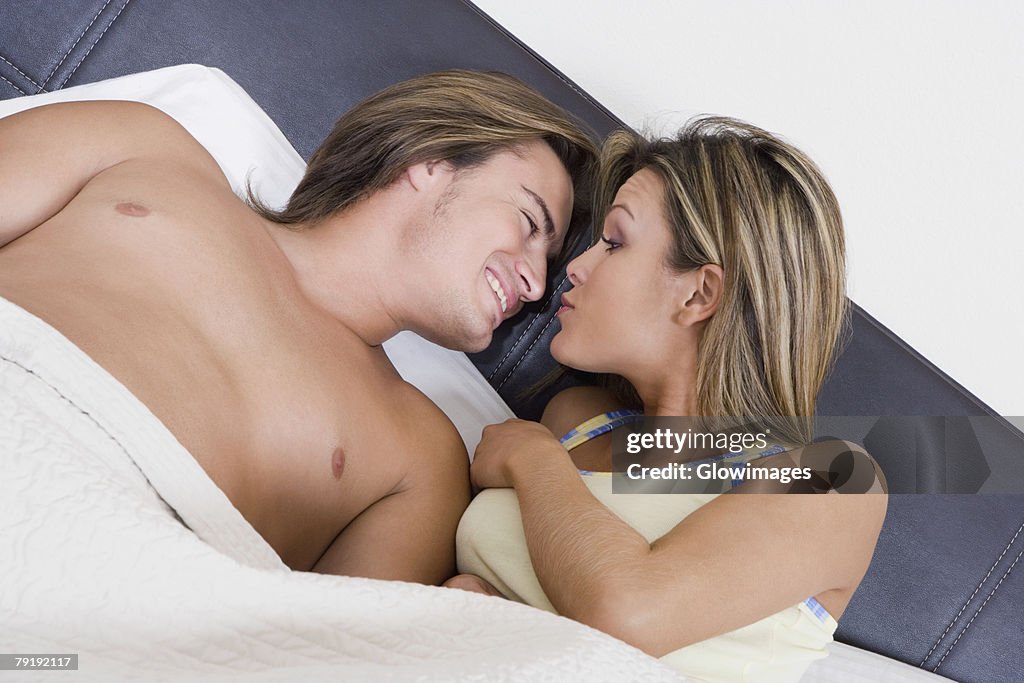 Young couple lying together on the bed