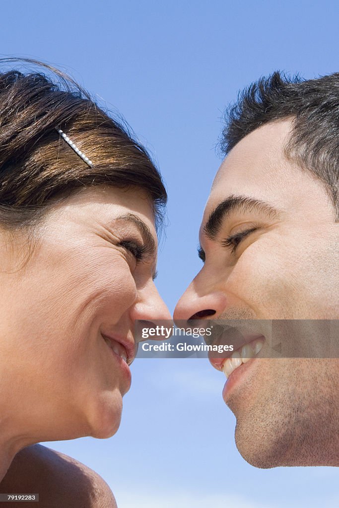 Close-up of a mid adult couple looking at each other with smiling