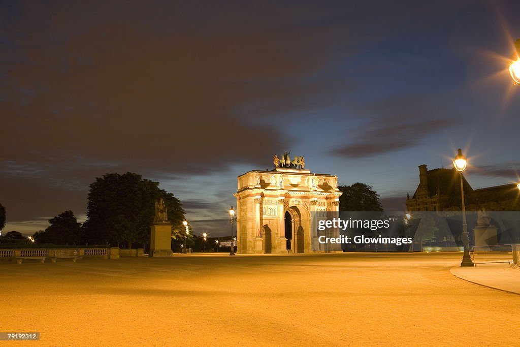 Triumphal arch lit up at night, Jardin De Tuileries, Paris, France