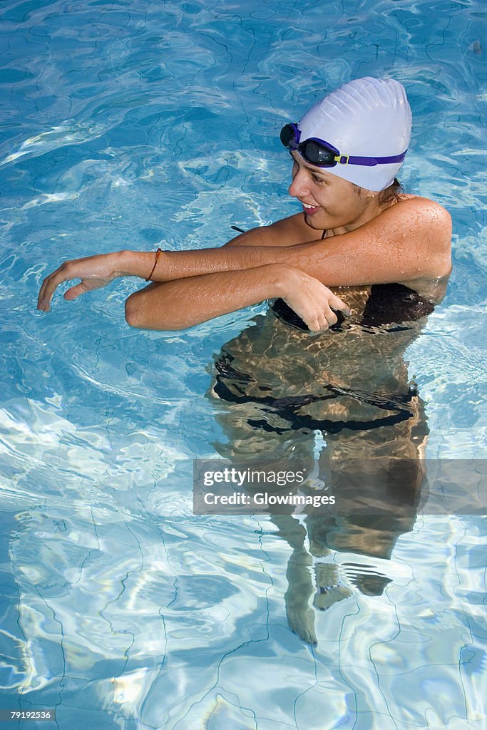 Young woman standing in a swimming pool