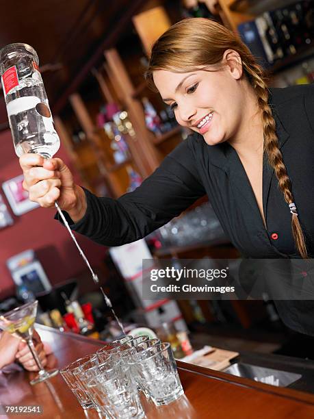 bartender making drinks at a bar counter - tequila pour stock pictures, royalty-free photos & images