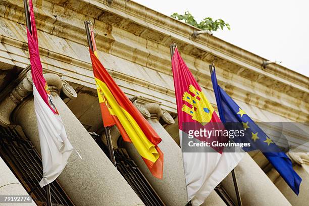 low angle view of four flags on a government building, toledo, spain - la mancha 個照片及圖片檔