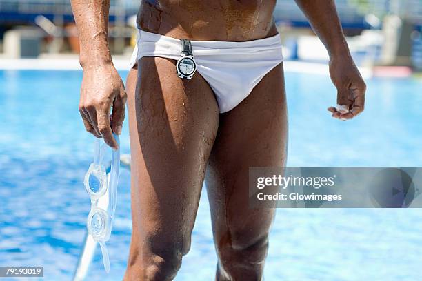 Man In Racing Briefs Standing Beside Pool Hands On Hips Mid Section  High-Res Stock Photo - Getty Images