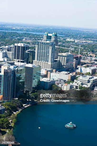 aerial view of buildings along a lake, lake eola, lake eola park, orlando, florida, usa - orlando florida aerial stock pictures, royalty-free photos & images