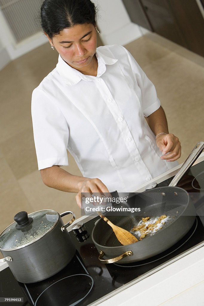 High angle view of a maid preparing food in the kitchen