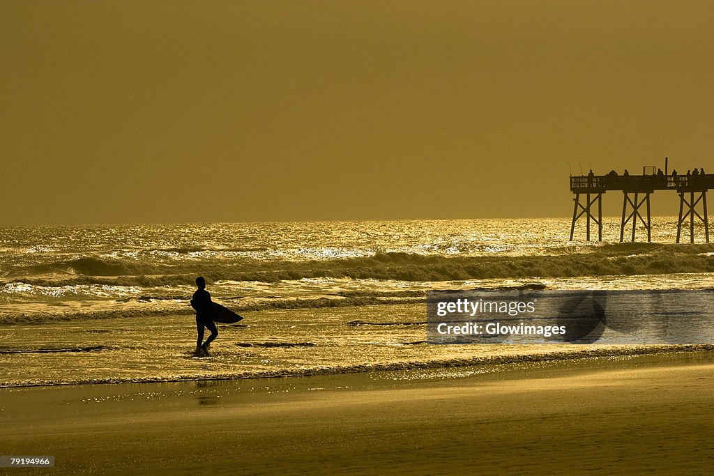 Silhouette of a person walking on the beach, Daytona Beach, Florida, USA