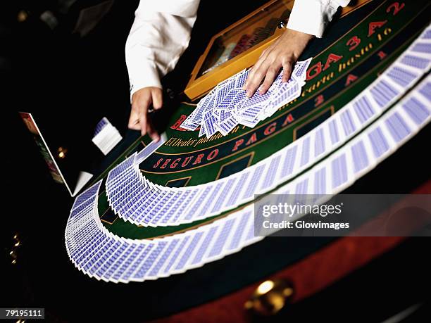 close-up of a casino worker's hand arranging gambling chips on a gambling table - black jack hand stock-fotos und bilder