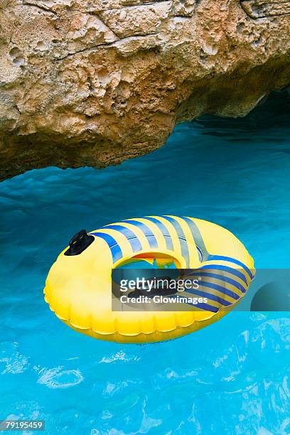 inflatable ring floating on water, cable beach, nassau, bahamas - cable beach bahamas stock pictures, royalty-free photos & images
