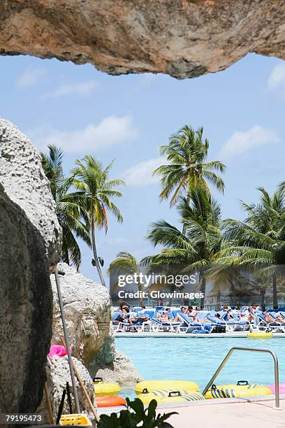 tourists relaxing in a tourist resort, cable beach, nassau, bahamas - cable beach bahamas stock pictures, royalty-free photos & images