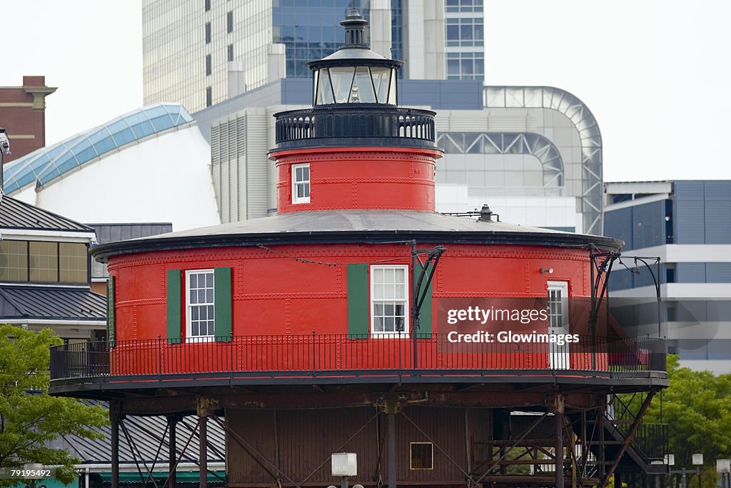 Lighthouse in front of buildings, Seven Foot Knoll Lighthouse, Inner Harbor, Baltimore, Maryland, USA