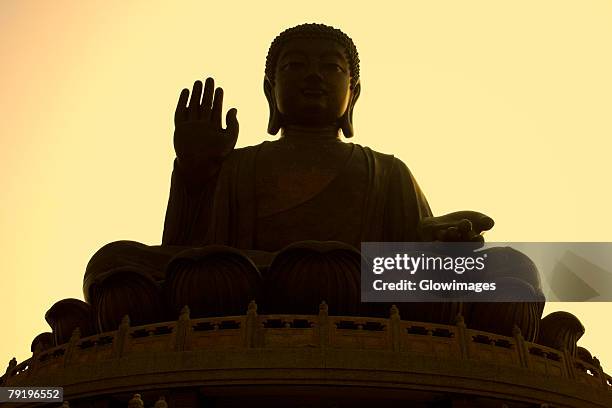 low angle view of a statue of buddha, tian tan buddha, po lin monastery, ngong ping, lantau, hong kong, china - mosteiro de po lin imagens e fotografias de stock