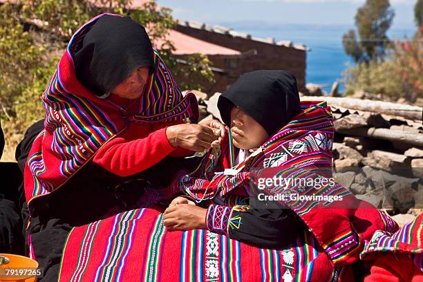 mid adult woman grooming a bride for wedding, taquile island, lake titicaca, puno, peru - peruvian culture imagens e fotografias de stock