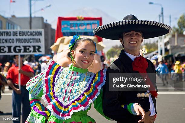 portrait of a young couple with arm in arm in a parade, arequipa, peru - couple placard stock pictures, royalty-free photos & images