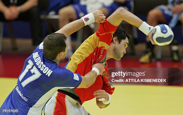 Spain's left back Raul Entrerrios Rodriguez is tackled by Iceland's pivot Sverre Jakobsson during their 8th Men's European Handball Championship Main...