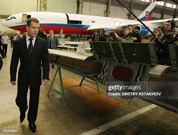 First Deputy Prime Minister and presidential candidate Dmitry Medvedev passes by a plane's wing during a visit to the Voronezh Aircraft Plant in...