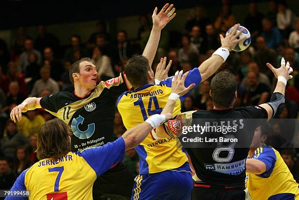 Holger Glandorf and Sebastian Preiss of Germany in action with Magnus Jernemyr and Robert Arrhenius of Sweden during the Men's Handball European...