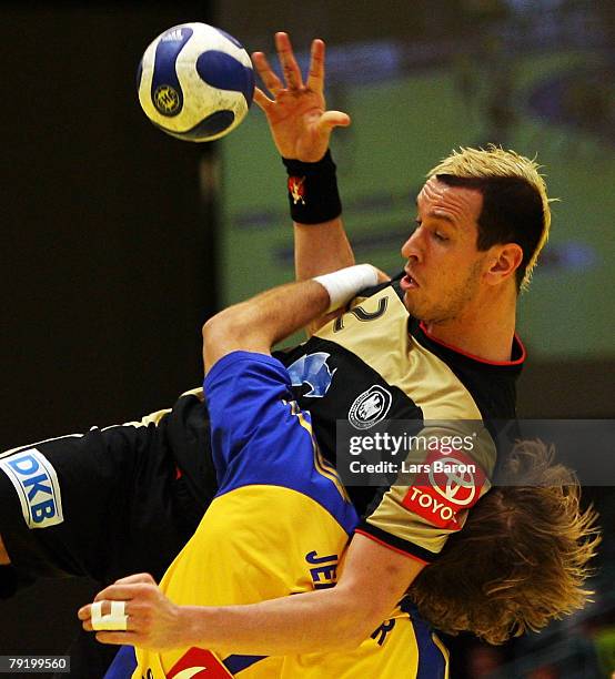 Pascal Hens of Germany in action with Magnus Jernemyr of Sweden during the Men's Handball European Championship main round Group II match between...