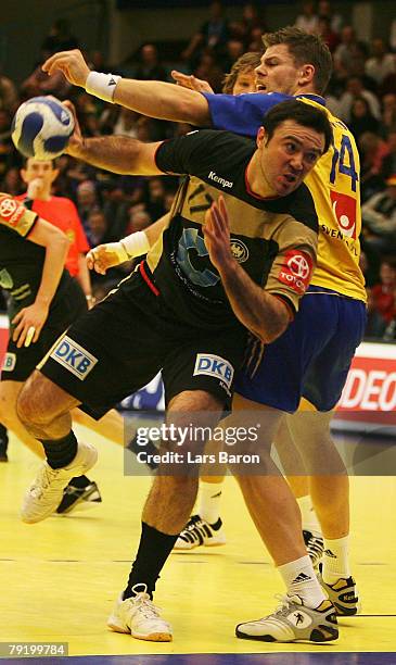 Andrej Klimovets of Germany in action with Robert Arrhenius of Sweden during the Men's Handball European Championship main round Group II match...