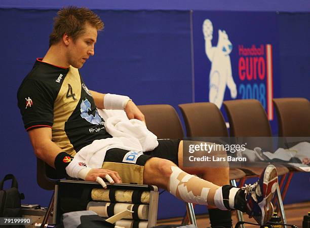 Oliver Roggisch of Germany sits injured on the bench during the Men's Handball European Championship main round Group II match between Germany and...