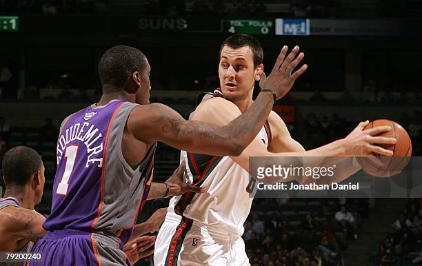 Andrew Bogut of the Milwaukee Bucks looks to move the ball against Amare Stoudemire of the Phoenix Suns at the Bradley Center on January 22, 2008 in...