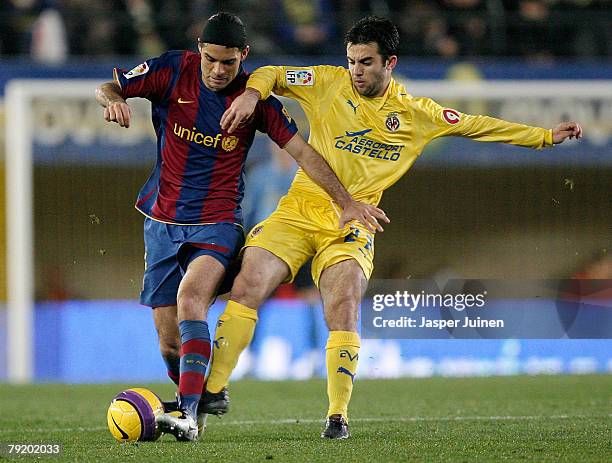 Rafael Marquez of Barcelona battles for the ball with Giuseppe Rossi of Villarreal during the Copa del Rey match at the El Madrigal stadium on...