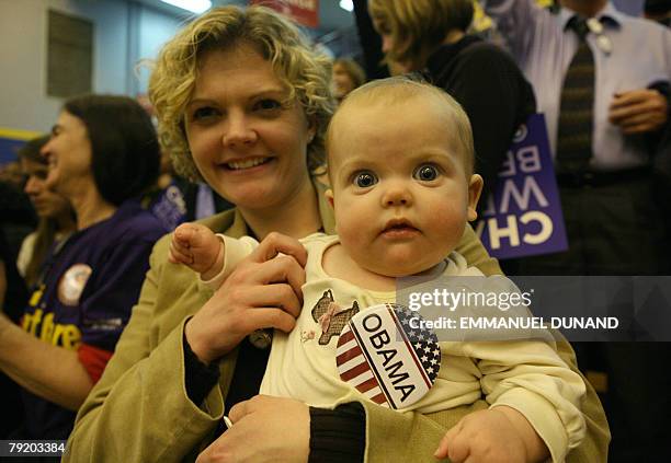 Supporter of US Democratic presidential candidate Barack Obama holds her child during a rally at North Charleston High School in North Charleston,...