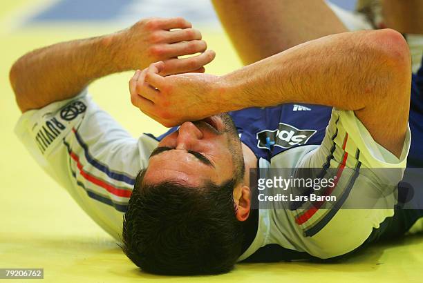 Nikola Karabatic of France lies injured on the pitch during the Men's Handball European Championship main round Group II match between Germany and...