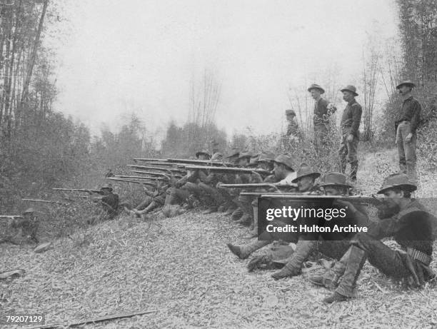 American troops fire on insurgents in the Philippine jungle during the Philippine-American War, circa 1899.