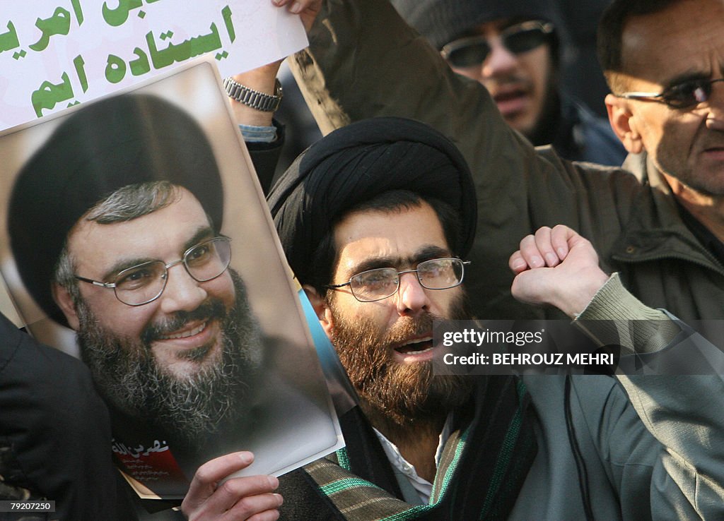 An Iranian cleric chants slogans while h