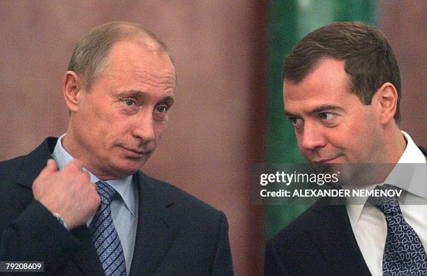 Russian President Vladimir Putin and First Deputy Prime Minister and presidential candidate Dmitry Medvedev speak during a document signing ceremony...