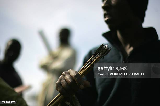 Member of the Luo tribe and supporters of Kenya's opposition leader Raila Odinga holds his bow and arrow during a rally and ethnic clashes between...