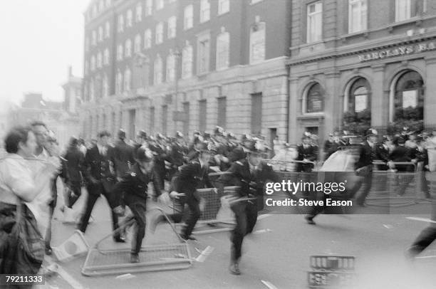 Police charge after rioting broke out at a demonstration against the Poll Tax, London, 31st March 1990.