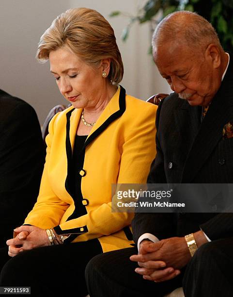Democratic presidential candidate Sen. Hillary Clinton prays with former New York City Mayor David Dinkins during a campaign event in the school...