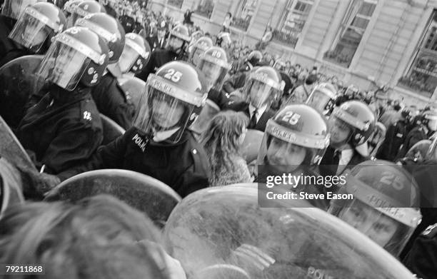 Police blocking off Whitehall as rioting breaks out during a demonstration against the Poll Tax, London, 31st March 1990.