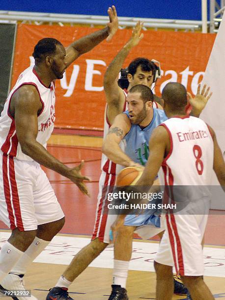 Iranian team Saba Battery's players Garth Joseph , Makan Dioumassi and Karam Ahmadian corner Fadi al-Khatib of Lebanon's Al-Riyadi club during their...