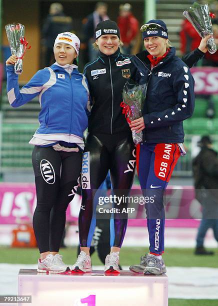 Jenny Wolf of Germany , Sang-Hwa Lee of Korea, and Marianne Timmer of the Netherlands pose on the podium in womens 500m event during the speedskating...