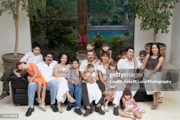 portrait of large hispanic family - crowded home stock-fotos und bilder