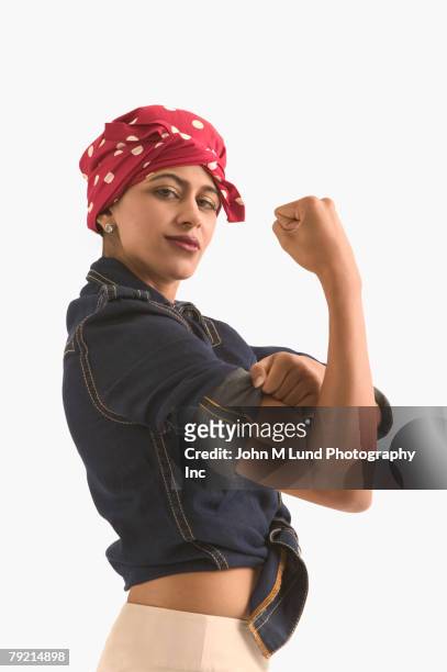 young woman dressed as ?rosie the riveter? - rosie the riveter stock pictures, royalty-free photos & images