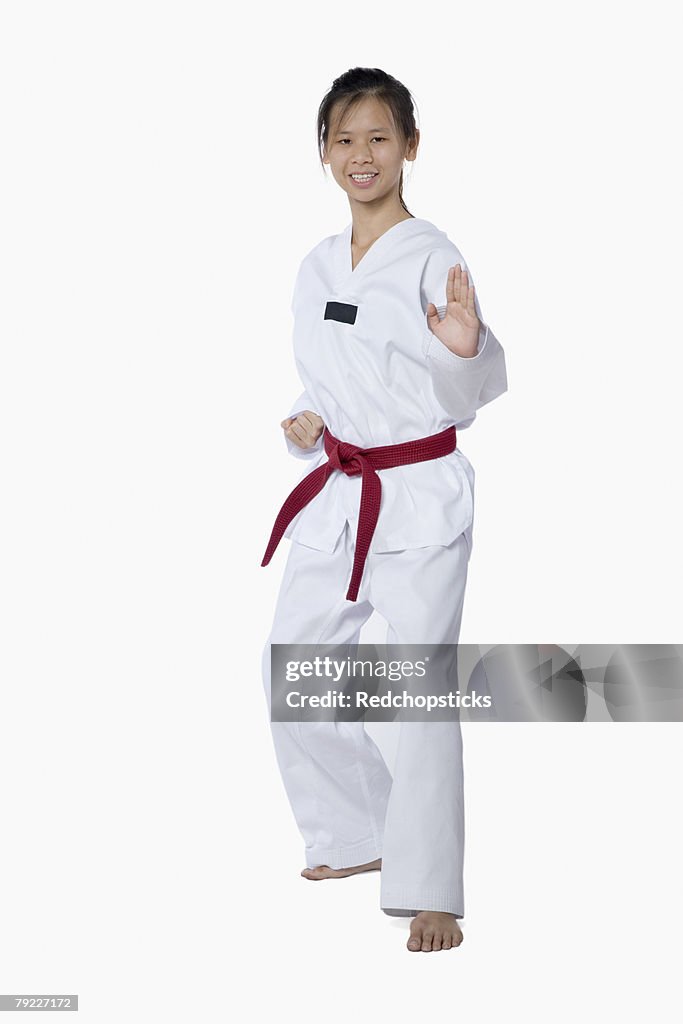 Young woman practicing karate and smiling