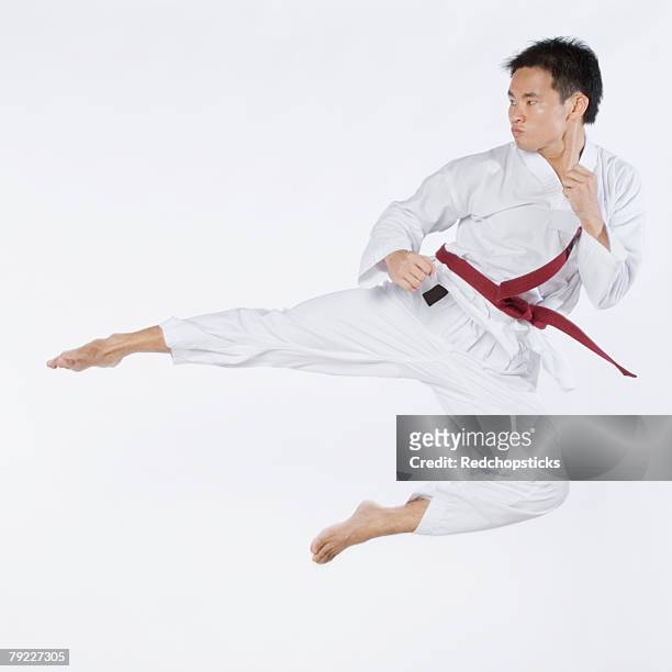young man performing flying kick - mens judo fotografías e imágenes de stock